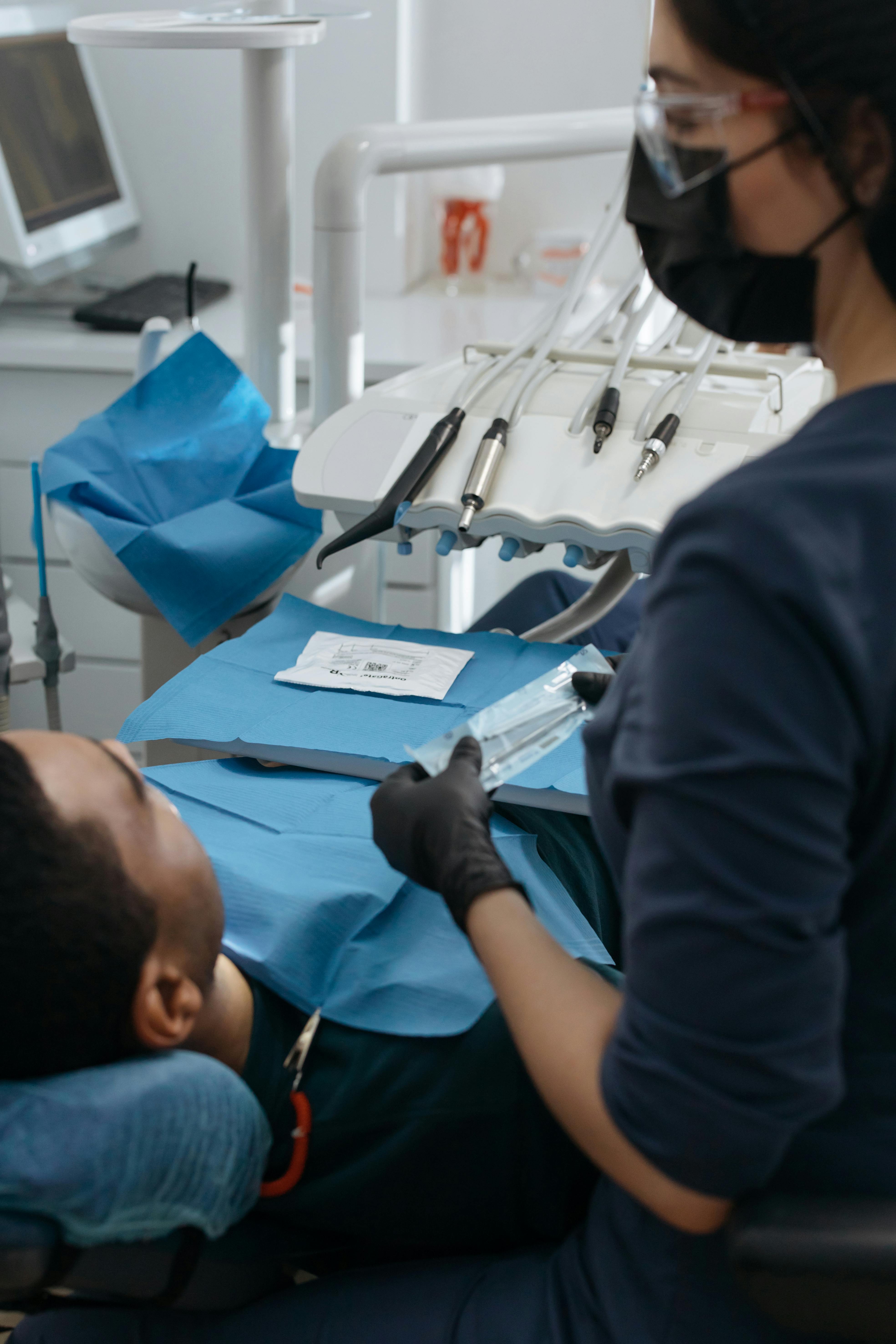 AURA Dental - Dentist providing care to patient in modern dental office